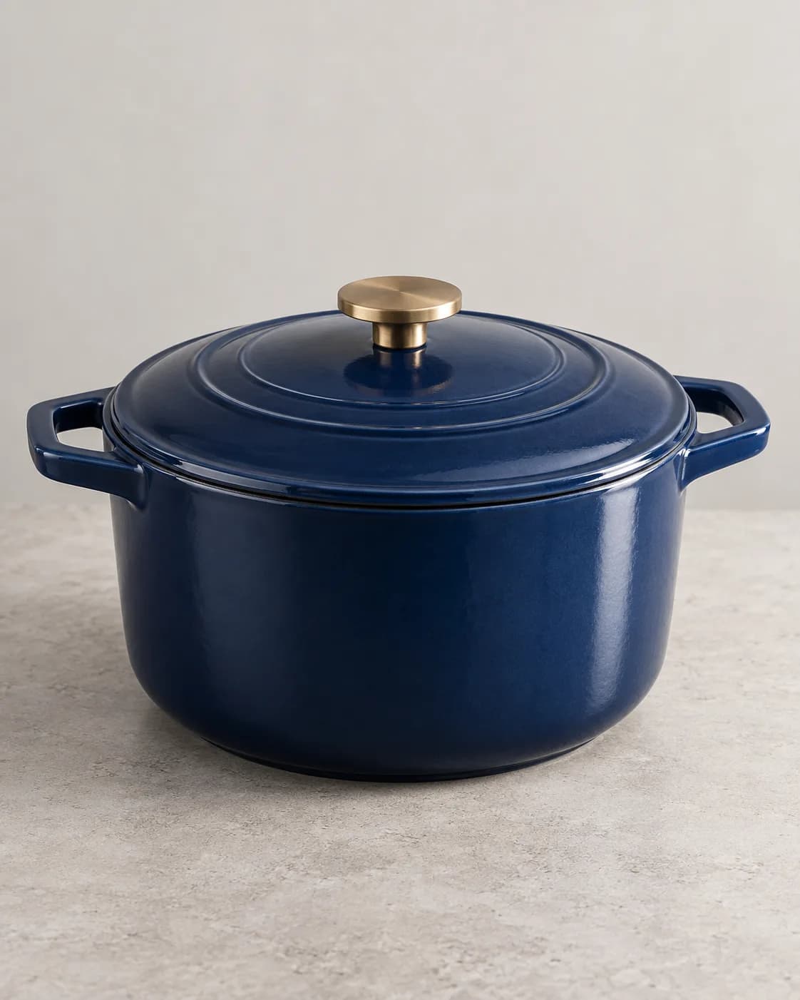 Blue enameled Dutch oven in a plain seller product photo