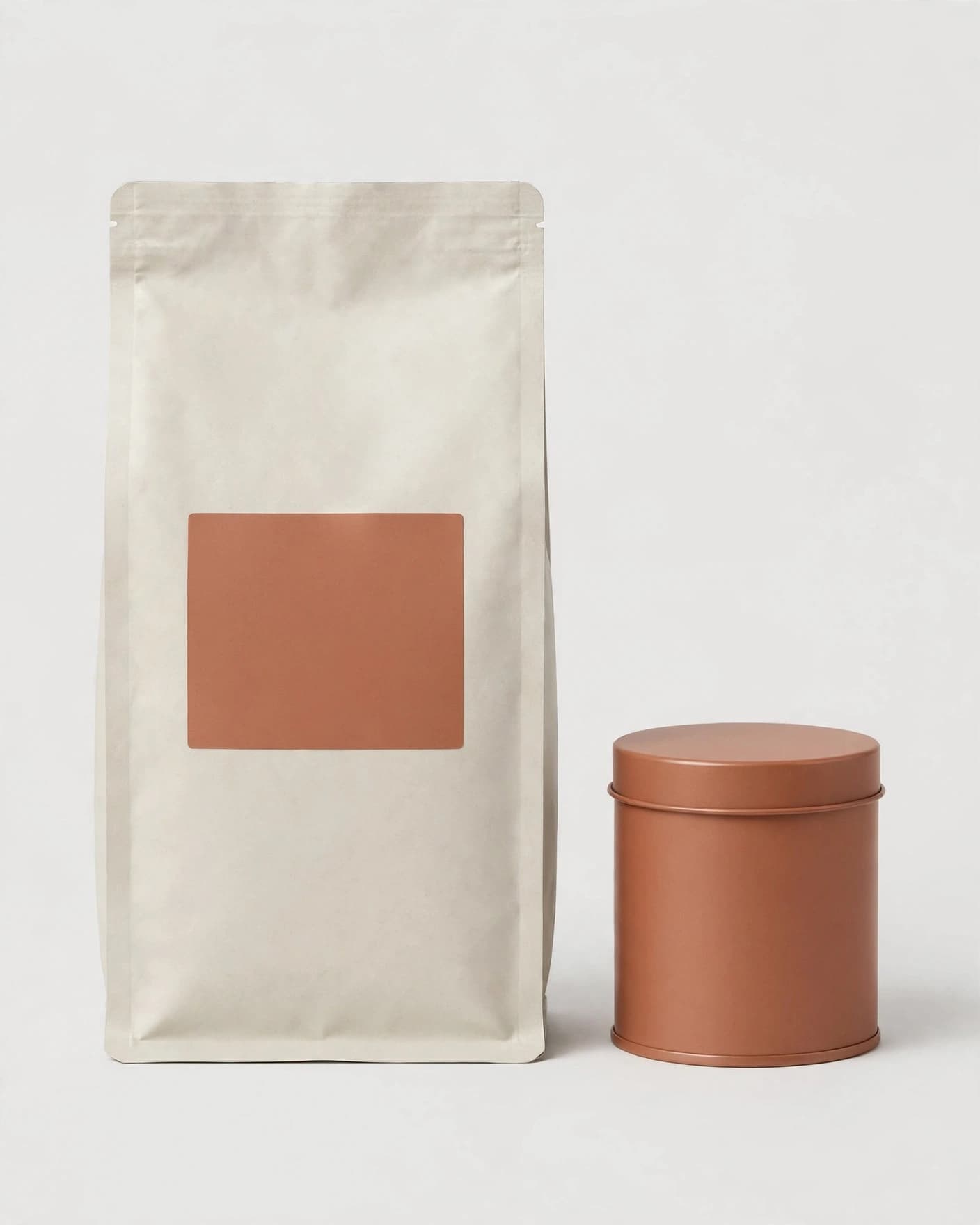 Off-white coffee bag and terracotta tin on a plain ecommerce background