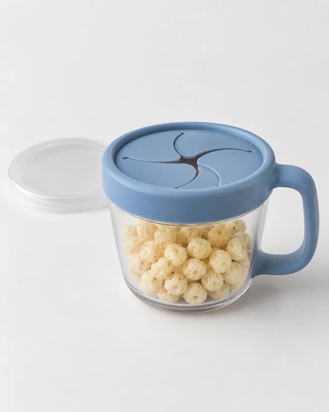 Blue toddler snack cup with its travel lid in a clean seller product photo