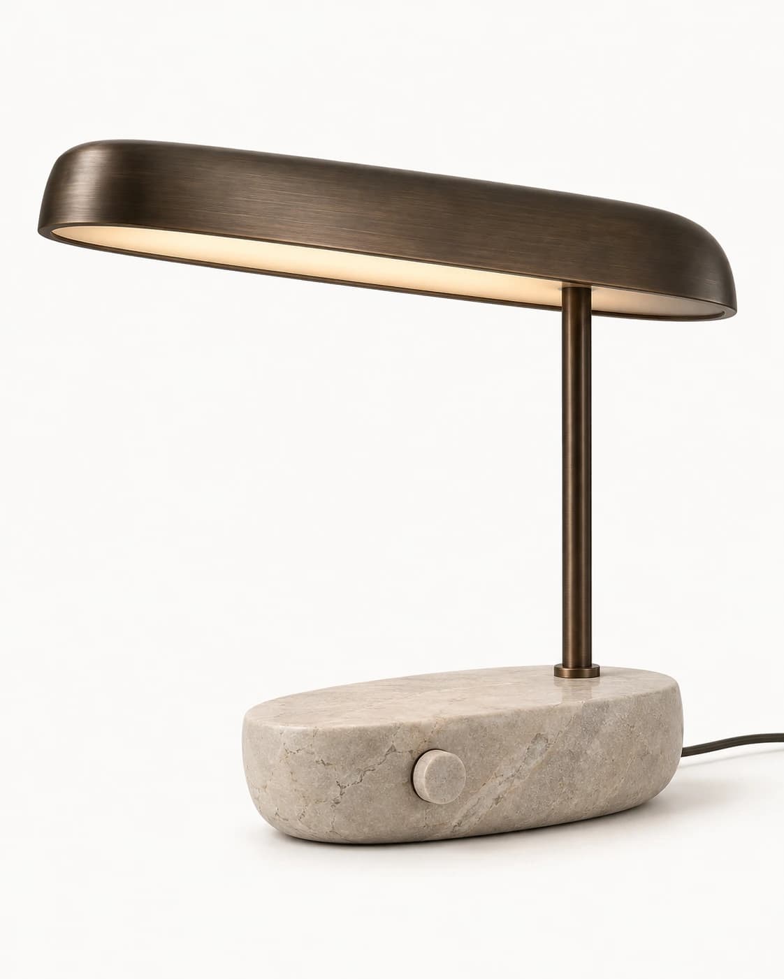 Limestone and aged-bronze oval table lamp on a warm-white studio background before editing