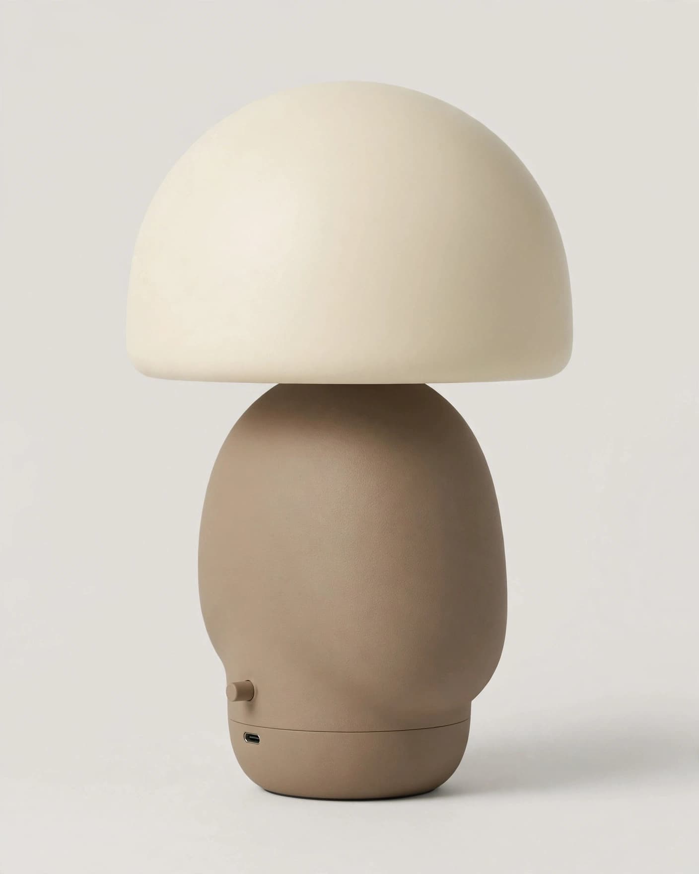 Cream dome table lamp with taupe base on a plain product background