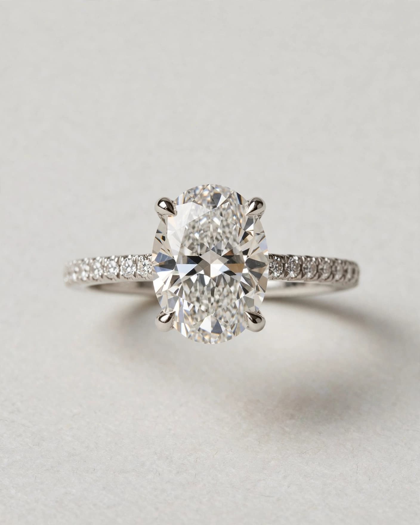 Oval-cut diamond engagement ring in a simple seller product photo