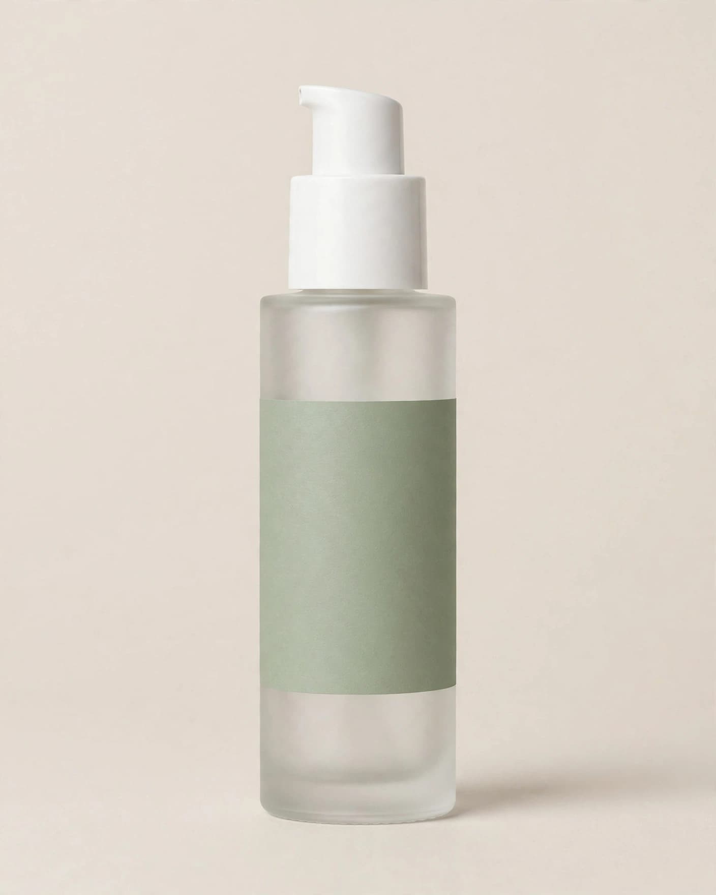Frosted skincare serum bottle with sage-green label on a plain beige background